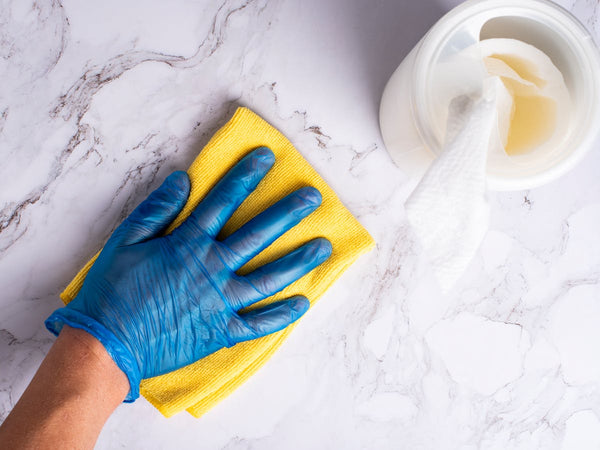 Gloved hand with cleaning cloth