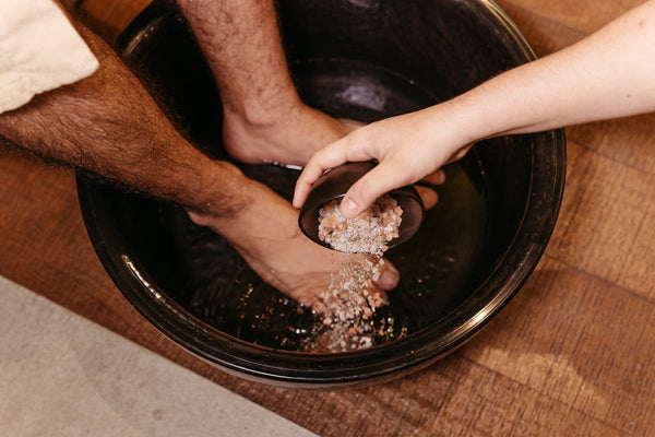 Man soaking feet in spa