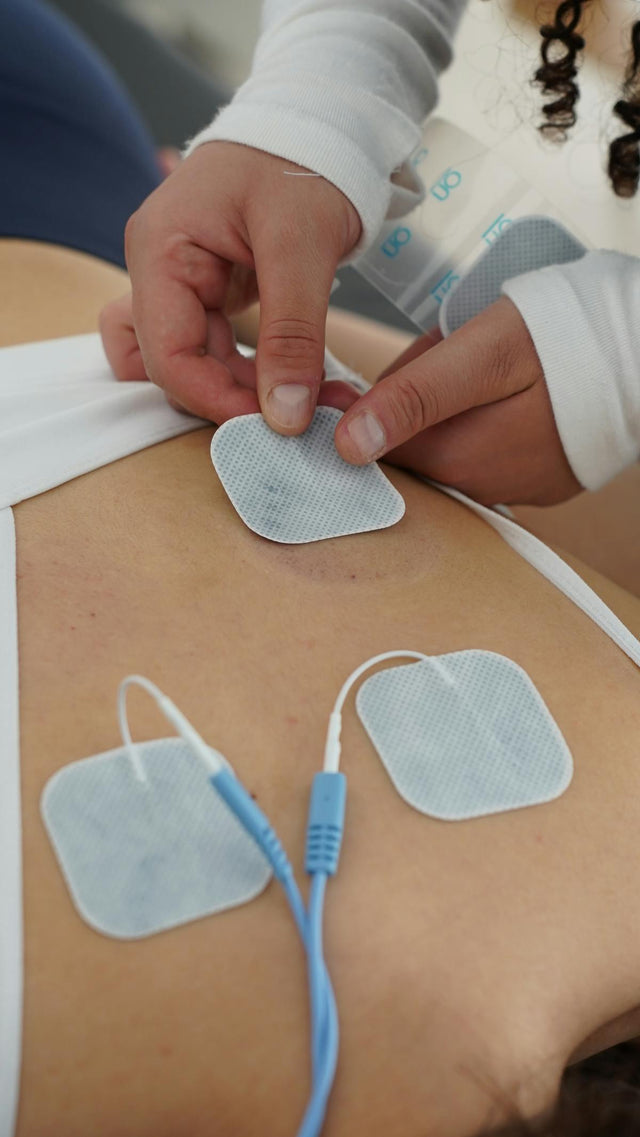 Electrotherapy pads on back