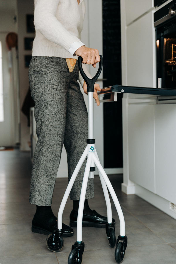 Senior with walker in kitchen