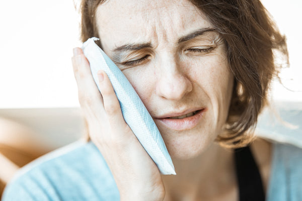 Woman applying cold compress