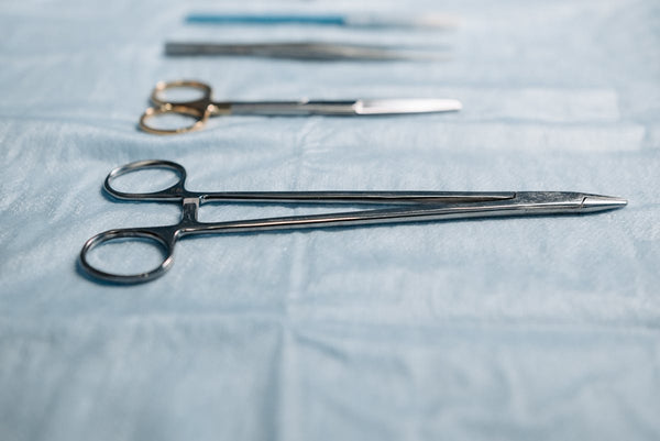 Surgical needle holder on blue cloth