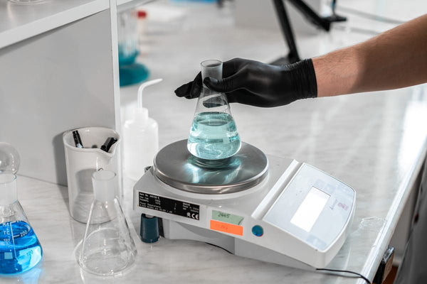 Scientist using laboratory scale