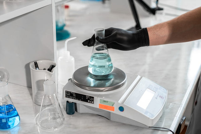 Scientist using laboratory scale